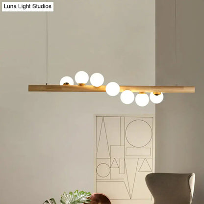 Minimalist beige wood island pendant with globe lights dining room