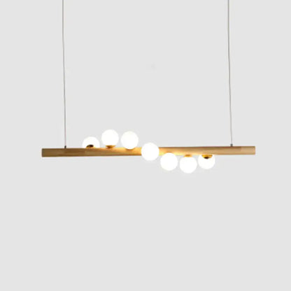 Minimalist beige wood island pendant with globe lights dining room