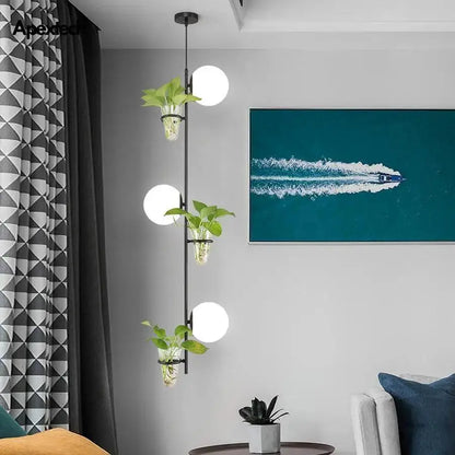 Modern black pendant planter light with glass globes dining room