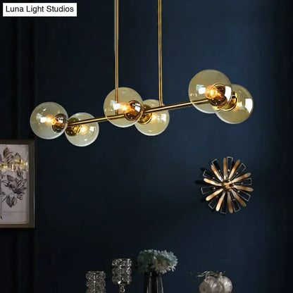 Postmodern gold kitchen island light with globe glass shade