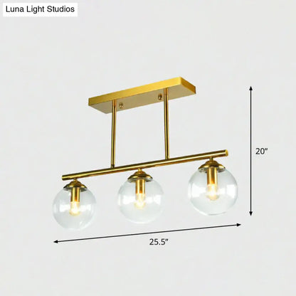 Postmodern gold kitchen island light with globe glass shade