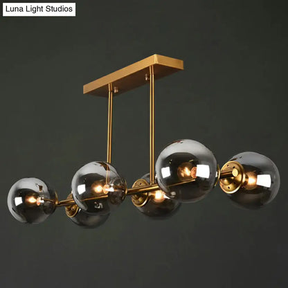 Postmodern gold kitchen island light with globe glass shade