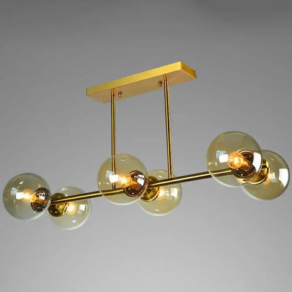 Postmodern gold kitchen island light with globe glass shade