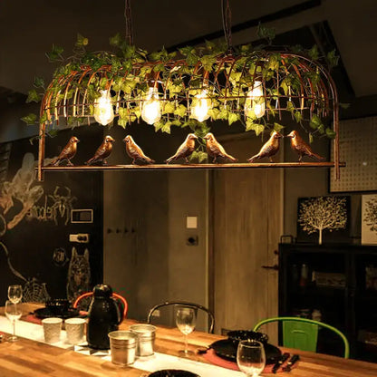 Rustic black birdcage island light with ivy for dining room