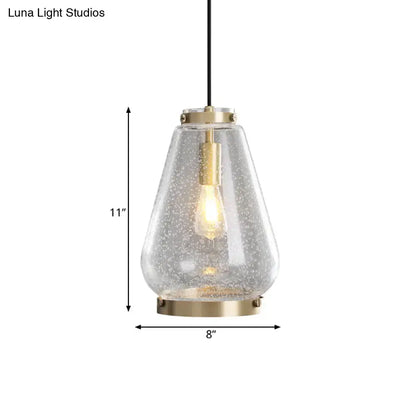 Modern seeded glass pendant light with brass rim bedroom