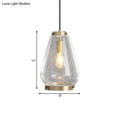Modern seeded glass pendant light with brass rim bedroom