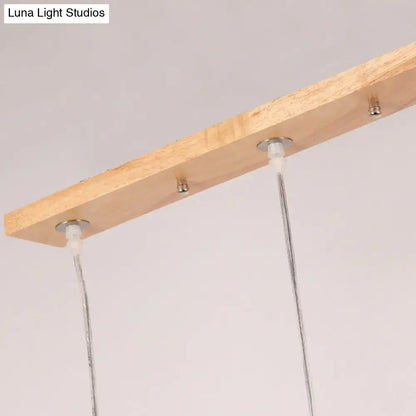Minimalist wood island pendant light with opaline glass dining room