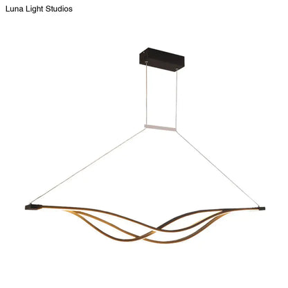 Modern black and gold wave shaped island light fixture dining room