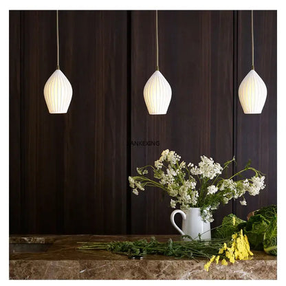 Elegance ribbed ceramic pendant lights in white and gold dining room