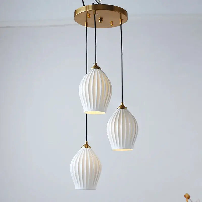 Elegance ribbed ceramic pendant lights in white and gold dining room