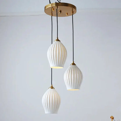 Elegance ribbed ceramic pendant lights in white and gold dining room