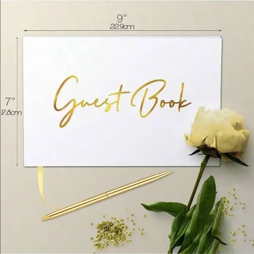 Elegant white guest book with bronzing detail – wedding reception