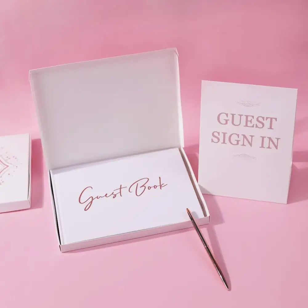 Elegant white guest book with bronzing detail – wedding reception