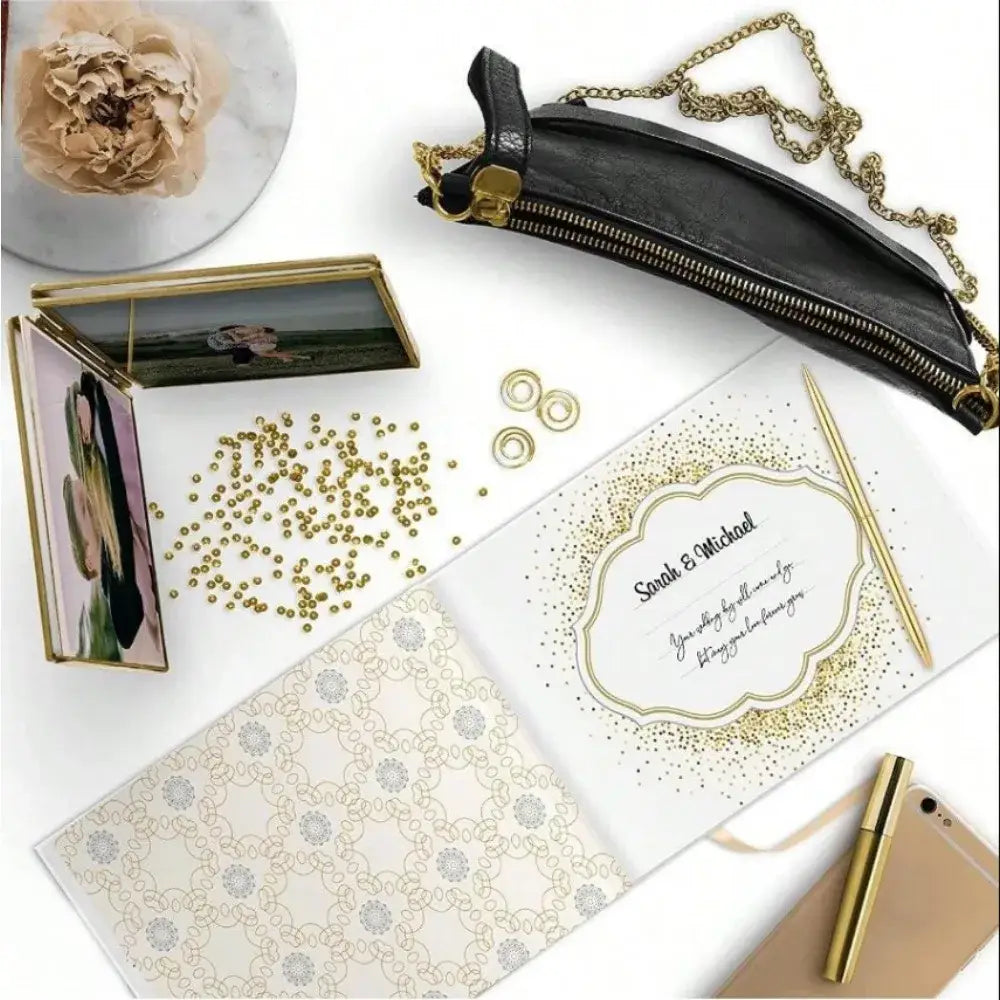 Elegant white guest book with bronzing detail – wedding reception