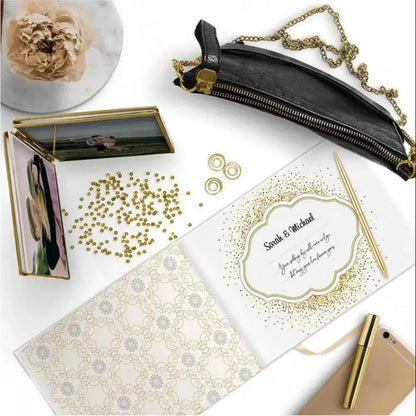 Elegant white guest book with bronzing detail – wedding reception