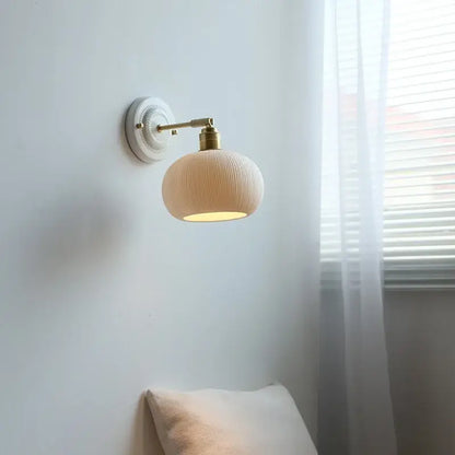 Fluted cream ceramic wall lamp with brass accents – bathroom light