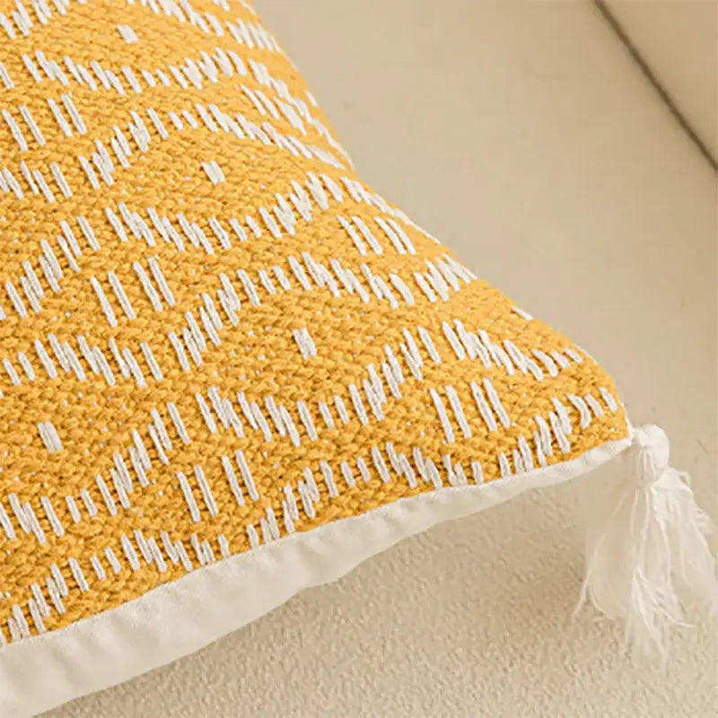 Geometric tufted yellow cushion cover with crochet tassels living room