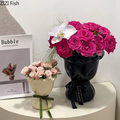 Glossy black ceramic vase with pink artificial flowers bedroom decor
