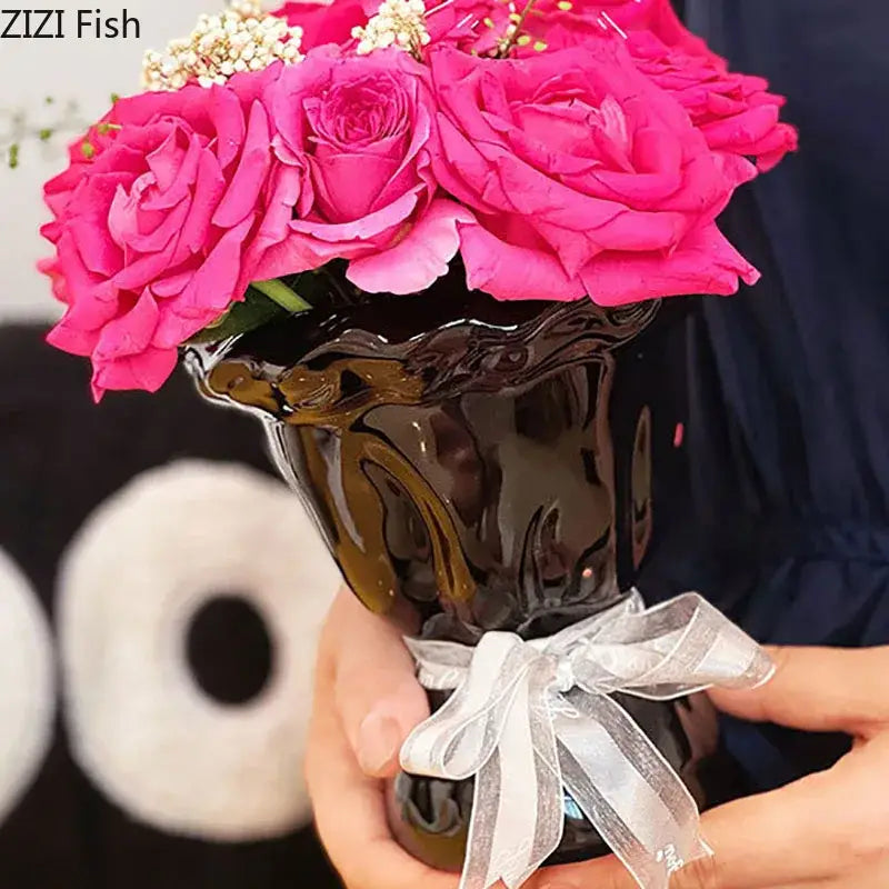 Glossy black ceramic vase with pink artificial flowers bedroom decor