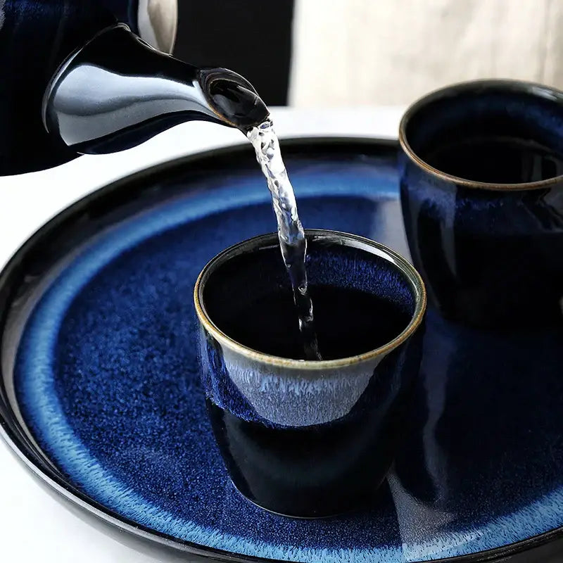 Glossy blue ceramic tea kettle set with bamboo handle dining room