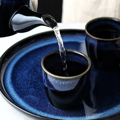 Glossy blue ceramic tea kettle set with bamboo handle dining room