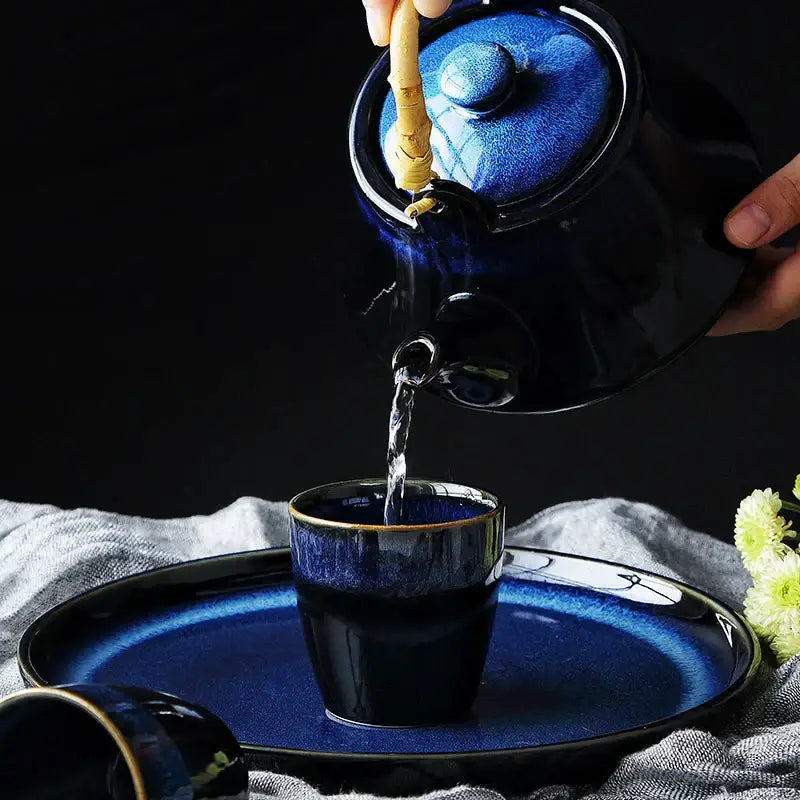 Glossy blue ceramic tea kettle set with bamboo handle dining room