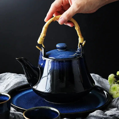 Glossy blue ceramic tea kettle set with bamboo handle dining room