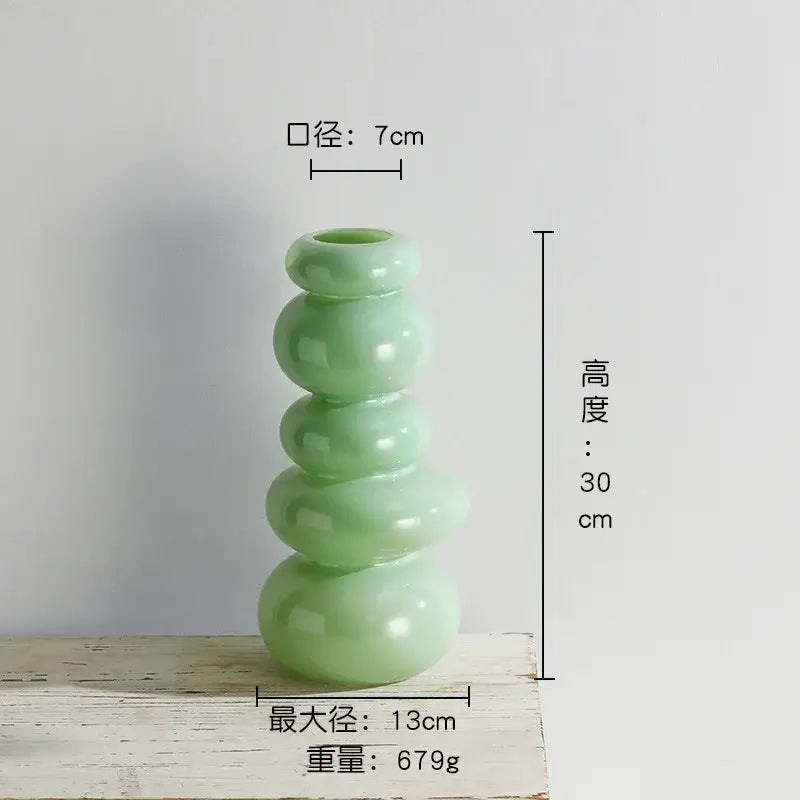 Glossy pastel pink pebble stack floral arrangement living room vase
