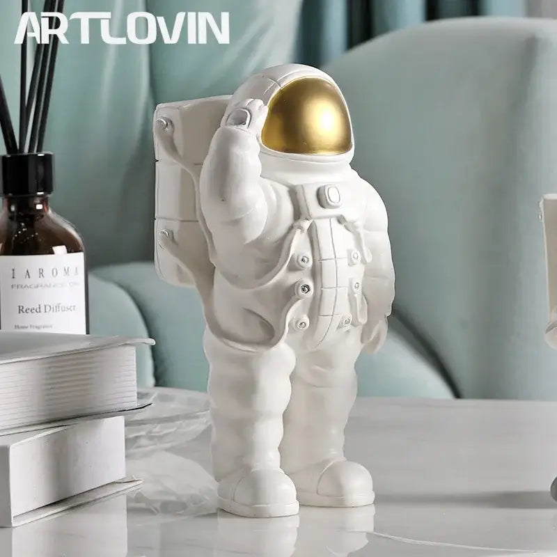 Glossy white and gold astronaut phone holder bedroom decor sculpture