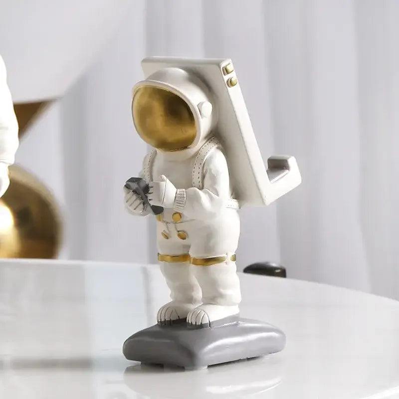 Glossy white and gold astronaut phone holder bedroom decor sculpture