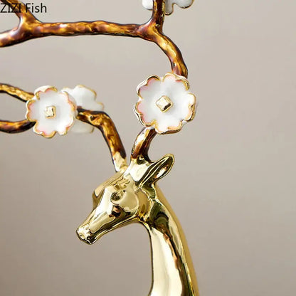 Golden deer antlers statue with white blossoms living room decor