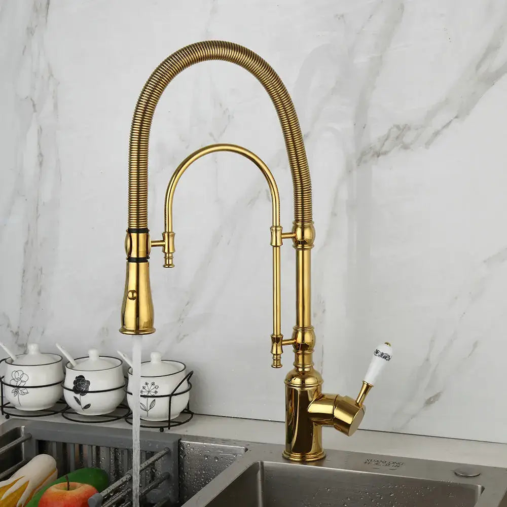 Golden kitchen faucet with white ceramic handle and swivel spout