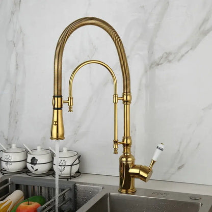 Golden kitchen faucet with white ceramic handle and swivel spout
