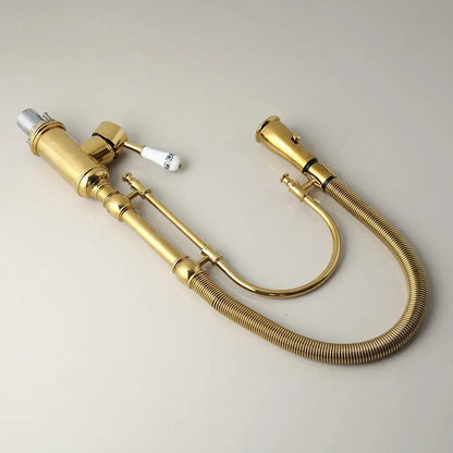 Golden kitchen faucet with white ceramic handle and swivel spout
