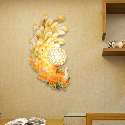 Golden peacock wall light with crystal shade – living room yellow & green