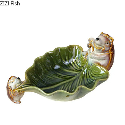 Green ceramic leaf decor tray with porcupines for dining room storage