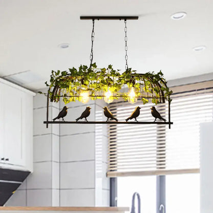 Industrial black birdcage kitchen pendant light with plant decoration