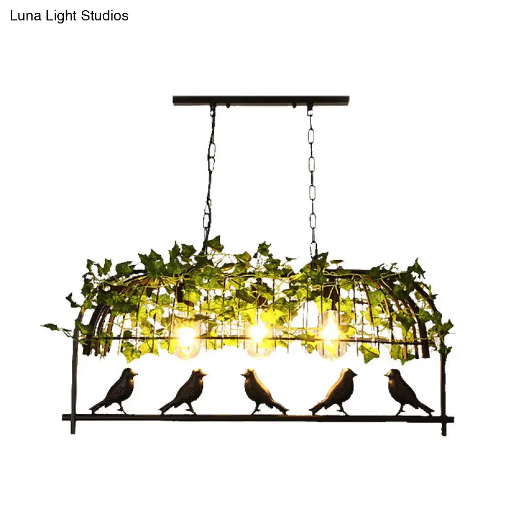 Industrial black birdcage kitchen pendant light with plant decoration