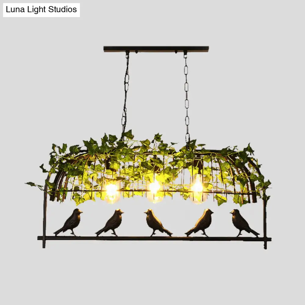 Industrial black birdcage kitchen pendant light with plant decoration
