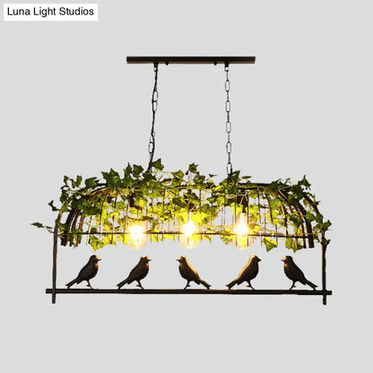Industrial black birdcage kitchen pendant light with plant decoration