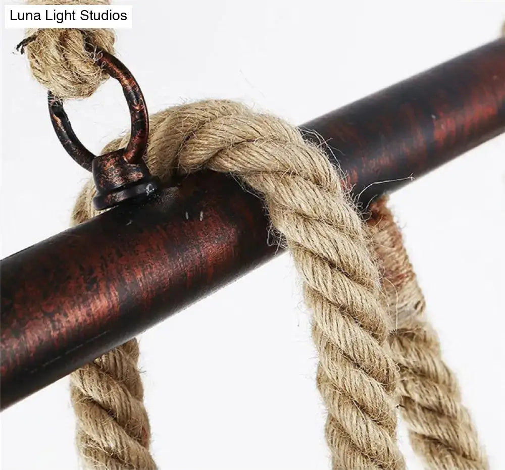 Industrial black pipe and rope chandelier for linear restaurant island