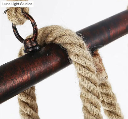 Industrial black pipe and rope chandelier for linear restaurant island