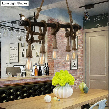 Industrial black pipe and rope chandelier for linear restaurant island