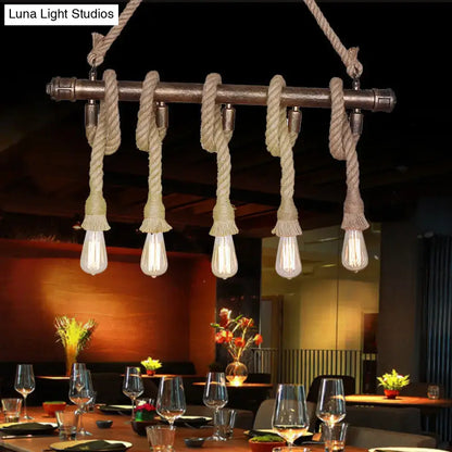 Industrial black pipe and rope chandelier for linear restaurant island