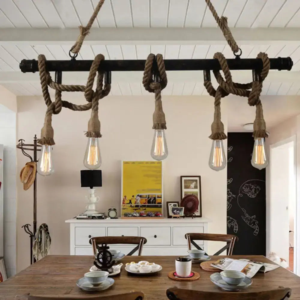 Industrial black pipe and rope chandelier for linear restaurant island