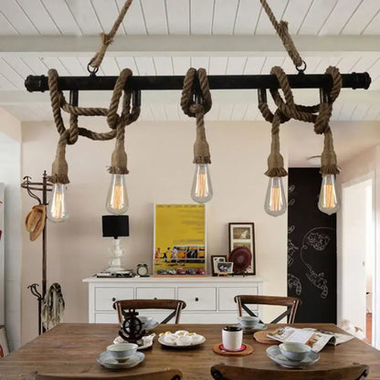 Industrial black pipe and rope chandelier for linear restaurant island