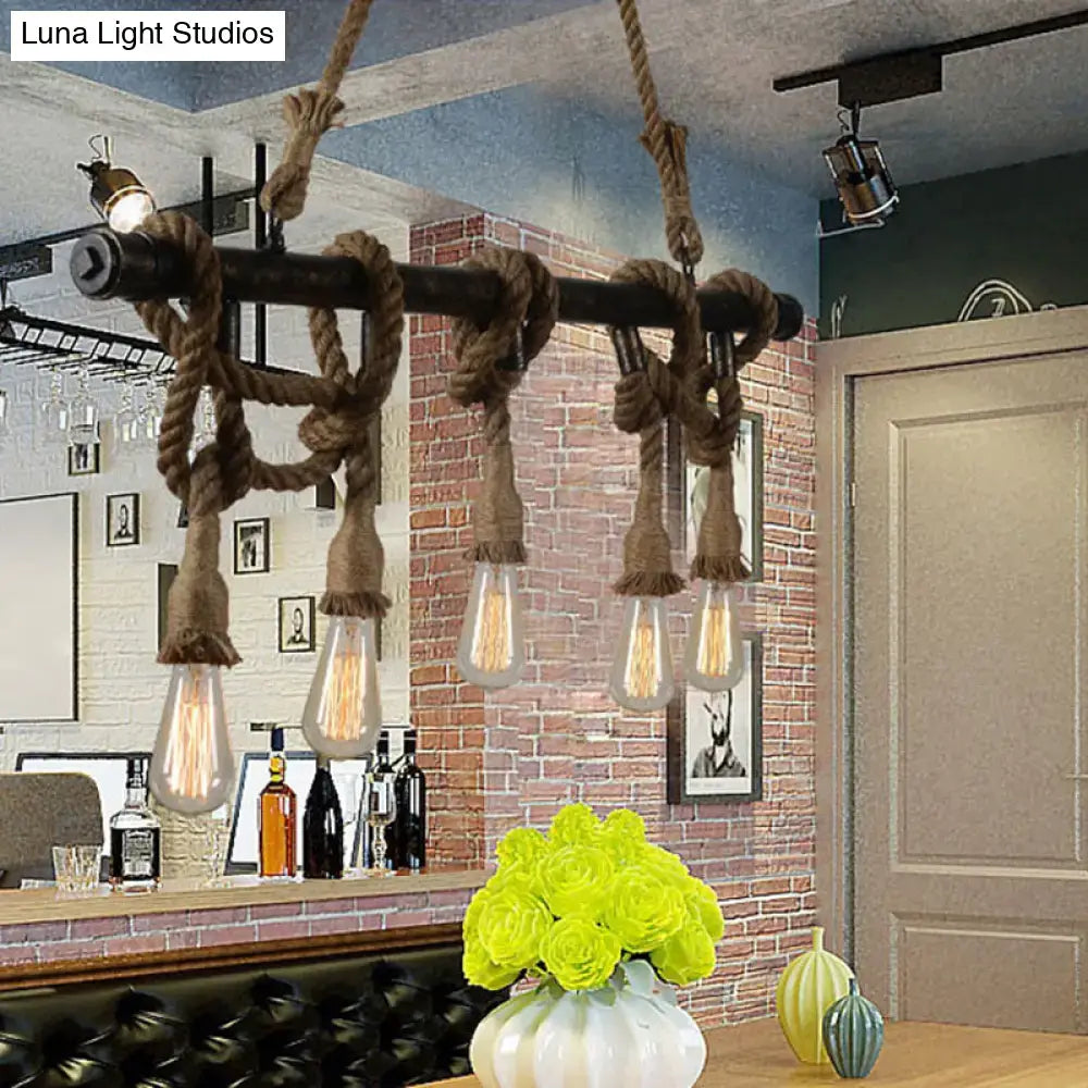 Industrial black pipe and rope chandelier for linear restaurant island