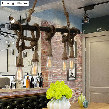 Industrial black pipe and rope chandelier for linear restaurant island