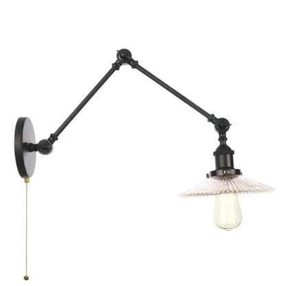 Industrial black swing arm wall light fixture with faceted glass shade