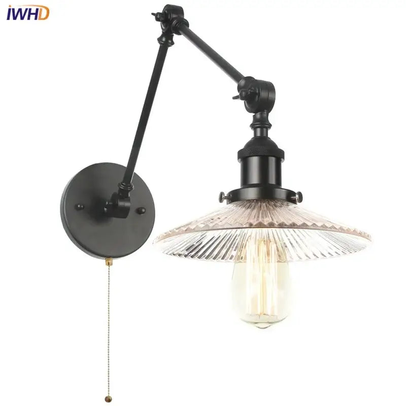 Industrial black swing arm wall light fixture with faceted glass shade